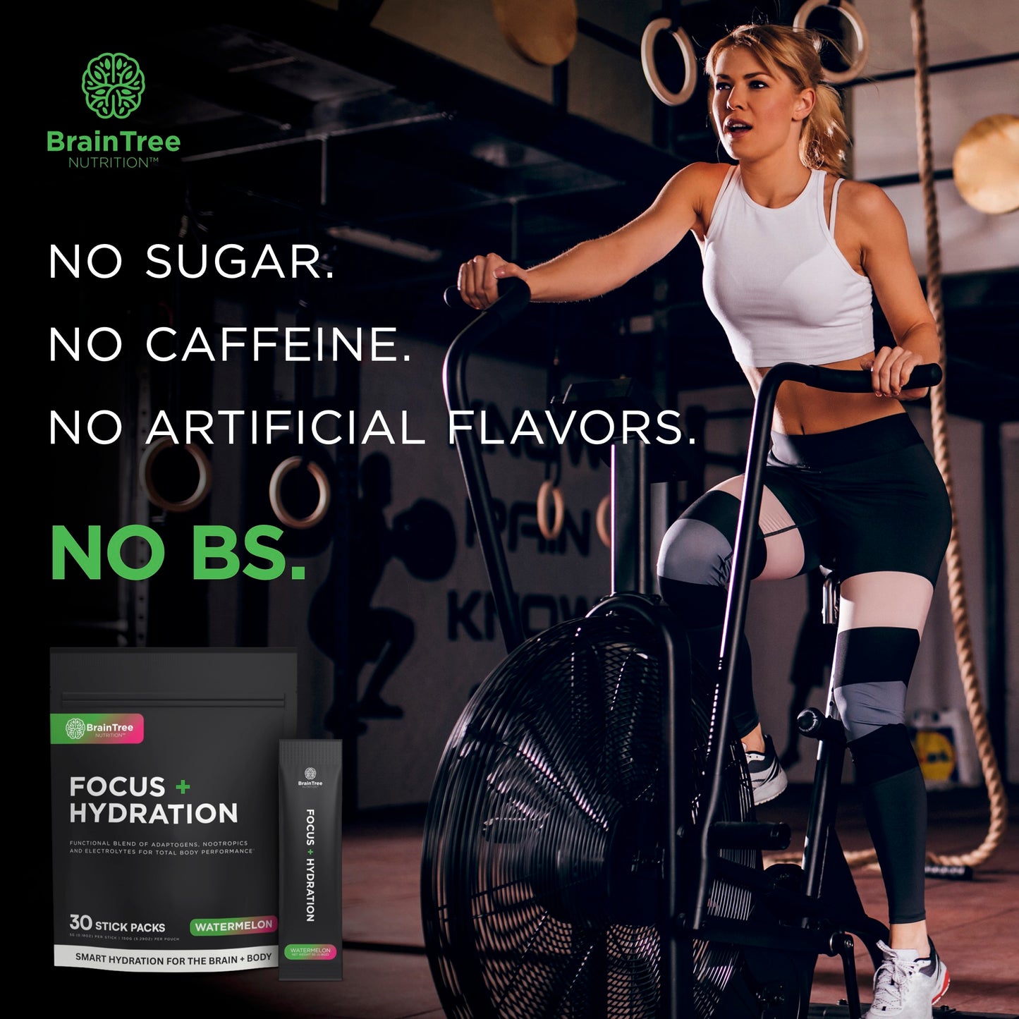 Woman training on assault bike using watermelon hydration and nootropic drink for clean focus and energy.